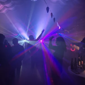 Binnenkant van de opblaasbare partytent met dansende gasten, discobal en laserverlichting